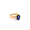 2.32 Carat Oval Cut Blue Sapphire with Trillion Cut Diamond Side stones in 18k Yellow Gold Ring